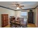 Dining room features a wood table, wooden chairs, a ceiling fan and two cabinets for storage at 6398 Sw 108Th St, Ocala, FL 34476