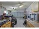 Spacious two-car garage with ample storage, work bench and two ceiling fans at 6398 Sw 108Th St, Ocala, FL 34476