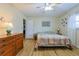 Bedroom with wood floors, ceiling fan, and furnishings at 6398 Sw 108Th St, Ocala, FL 34476