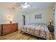 Bedroom with wood floors, ceiling fan, furnishings, and neutral paint at 6398 Sw 108Th St, Ocala, FL 34476