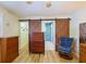 Main bedroom with rustic barn door leading to bathroom, hardwood floors, and natural light at 6398 Sw 108Th St, Ocala, FL 34476