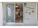 Outdoor patio area with a view into the dining room, illuminated by an exterior light at 6398 Sw 108Th St, Ocala, FL 34476