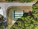 Aerial image of the community's shuffleboard court surrounded by mature trees at 6398 Sw 108Th St, Ocala, FL 34476