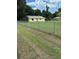 Expansive backyard with a chain-link fence and a view of the home's rear exterior at 6725 Nw 14Th Ave, Ocala, FL 34475