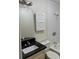 Functional bathroom with white tile shower/tub, vanity with black top and storage at 6725 Nw 14Th Ave, Ocala, FL 34475
