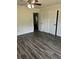 Bedroom featuring wood-look floors, ceiling fan, and access to closets at 6725 Nw 14Th Ave, Ocala, FL 34475