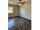 Bedroom highlighting wood-look floors and natural light from a window at 6725 Nw 14Th Ave, Ocala, FL 34475
