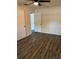 Bedroom showcasing wood-look floors, ceiling fan, and access to other rooms at 6725 Nw 14Th Ave, Ocala, FL 34475