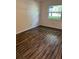 Bright bedroom featuring modern flooring and natural light from a window at 6725 Nw 14Th Ave, Ocala, FL 34475