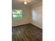 Bedroom featuring natural light from a window and wood-look vinyl flooring at 6725 Nw 14Th Ave, Ocala, FL 34475