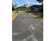 Wide paved driveway leads to this single-story home with covered parking at 6725 Nw 14Th Ave, Ocala, FL 34475