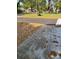 View of the driveway approaching the house with green lawn and trees surrounding at 6725 Nw 14Th Ave, Ocala, FL 34475