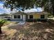 Charming single-story home with a lush green lawn and mature trees providing shade at 6725 Nw 14Th Ave, Ocala, FL 34475