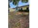 Charming single-story home features a yellow and gray exterior and a manicured lawn at 6725 Nw 14Th Ave, Ocala, FL 34475