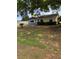 Charming single-story home features a yellow and gray exterior with manicured front lawn at 6725 Nw 14Th Ave, Ocala, FL 34475