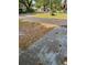 Home with view of the front yard, landscaping and asphalt road at 6725 Nw 14Th Ave, Ocala, FL 34475