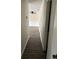 Hallway leading into an open space, showcasing laminate flooring and ceiling fan at 6725 Nw 14Th Ave, Ocala, FL 34475