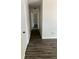 Hallway with wood grain floors and white walls at 6725 Nw 14Th Ave, Ocala, FL 34475