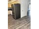Stainless steel refrigerator with painted cabinets and wood grain flooring at 6725 Nw 14Th Ave, Ocala, FL 34475