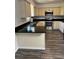 Well-equipped kitchen with black countertops, stainless steel appliances, and wood-look flooring at 6725 Nw 14Th Ave, Ocala, FL 34475