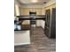 Traditional kitchen with stainless steel appliances, dark countertops, wood grain flooring, and painted cabinets at 6725 Nw 14Th Ave, Ocala, FL 34475