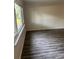 Bright living room featuring large windows and stylish gray wood-look flooring at 6725 Nw 14Th Ave, Ocala, FL 34475