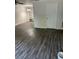 Open living room featuring wood-look floors, built-in shelving, and neutral paint at 6725 Nw 14Th Ave, Ocala, FL 34475