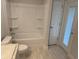 Bright bathroom featuring a bathtub, toilet, vanity and access to the backyard at 71 Nw 42Nd Pl, Ocala, FL 34475