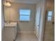Bright bathroom with a vanity, a window, and a tiled shower at 71 Nw 42Nd Pl, Ocala, FL 34475