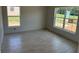Cozy bedroom with large windows, tiled floors, and white walls perfect for creating a relaxing space at 71 Nw 42Nd Pl, Ocala, FL 34475