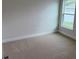 A sunlit bedroom features plush carpeting, a window letting in natural light, and neutral paint at 71 Nw 42Nd Pl, Ocala, FL 34475