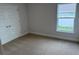Bright bedroom features plush carpeting, a window letting in natural light, and a double door closet at 71 Nw 42Nd Pl, Ocala, FL 34475