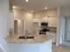 Bright kitchen featuring a granite countertop, stainless steel microwave, and ample cabinet space at 71 Nw 42Nd Pl, Ocala, FL 34475