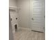 Well-lit laundry room with tile flooring and a storage shelf at 71 Nw 42Nd Pl, Ocala, FL 34475