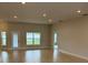 Spacious living room featuring tiled floors, recessed lighting, and backyard access at 71 Nw 42Nd Pl, Ocala, FL 34475