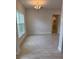 Open living room featuring tile flooring, a chandelier, and a large window at 71 Nw 42Nd Pl, Ocala, FL 34475