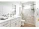 Well-lit bathroom featuring a tiled shower, vanity with sink, and modern fixtures at 8214 Nw 17Th Cir, Ocala, FL 34475