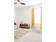 Well-lit bedroom with yellow curtains, furniture, and a ceiling fan at 8214 Nw 17Th Cir, Ocala, FL 34475