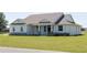 Charming one story home with stone accents, fresh green lawn, and a welcoming front porch at 8214 Nw 17Th Cir, Ocala, FL 34475