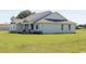 Exterior side view of the one-story home featuring a well-manicured lawn at 8214 Nw 17Th Cir, Ocala, FL 34475