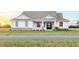 Charming single-Gathering home showcasing manicured lawn, covered entry, and decorative columns at 8214 Nw 17Th Cir, Ocala, FL 34475