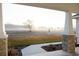 Covered front porch with decorative columns, offering views of the surrounding landscape at 8214 Nw 17Th Cir, Ocala, FL 34475