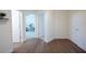 Hallway with hardwood flooring and doors leading into rooms, including an office at 8214 Nw 17Th Cir, Ocala, FL 34475