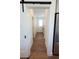 Hallway featuring hardwood flooring and doors leading to various rooms in the home at 8214 Nw 17Th Cir, Ocala, FL 34475
