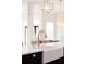 Close-up shot of a modern kitchen sink and faucet with a view into the dining and living areas at 8214 Nw 17Th Cir, Ocala, FL 34475