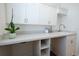 Bright laundry room with white cabinetry, a sink, and ample counter space, creating a functional area at 8214 Nw 17Th Cir, Ocala, FL 34475