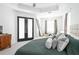 Relaxing main bedroom with tray ceilings, a king bed, and patio door access at 8214 Nw 17Th Cir, Ocala, FL 34475