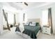 Serene main bedroom featuring a trey ceiling, large windows, and a tranquil, well-appointed ensuite at 8214 Nw 17Th Cir, Ocala, FL 34475