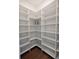 Spacious pantry featuring white shelving, wood floors, and ample storage to organize all your essentials at 8214 Nw 17Th Cir, Ocala, FL 34475