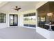 Covered patio featuring a ceiling fan, sliding glass doors, and a window with dining area view at 8214 Nw 17Th Cir, Ocala, FL 34475